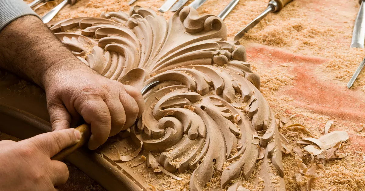 Craftsman carving wood details for handcrafted cabinets
