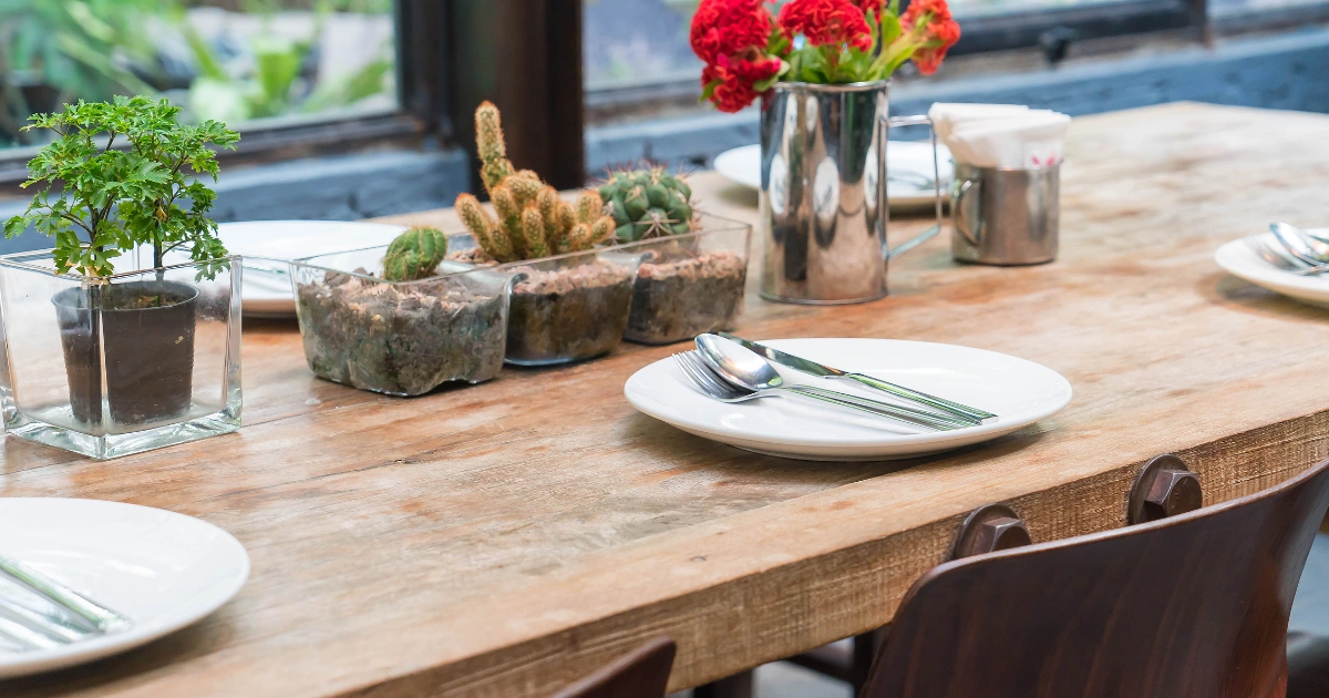 Rustic dining setup with greenery and decor on farmhouse dining tables