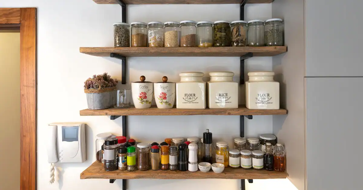 Kitchen storage with rustic wood shelves and organized spice jars highlighting open shelving vs. closed cabinets design ideas